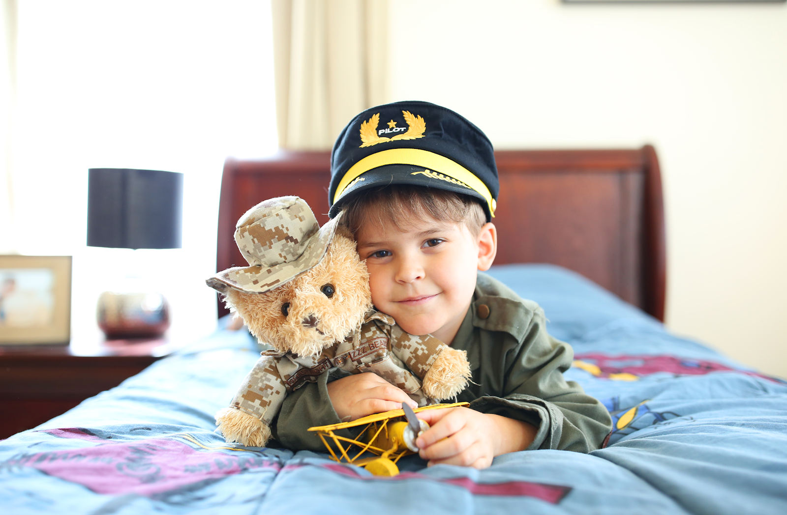 kid playing with military teddy bear