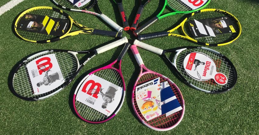 Different brands of tennis racquets on the court