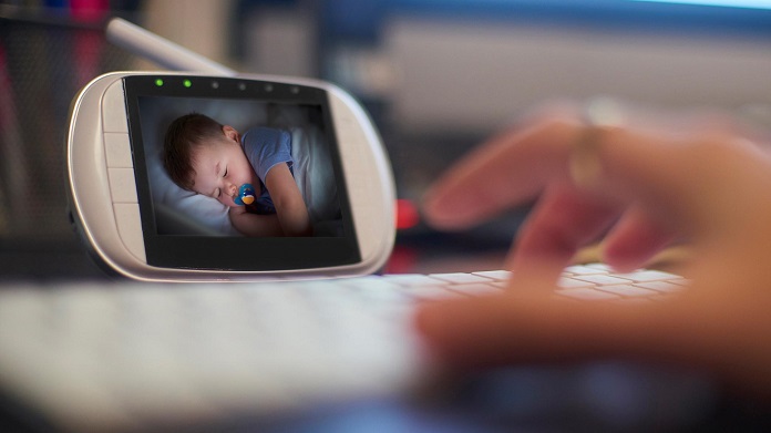 picture of a baby monitor in front a persons hand 