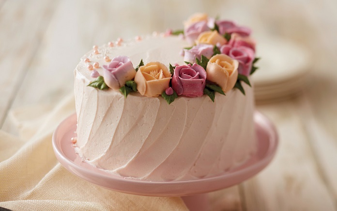 pink flower birthday cake on table 