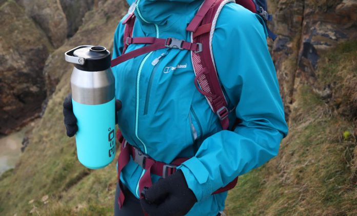Hiker holding blue water bottle for hiking