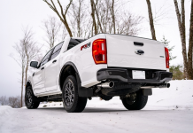 White Ford Ranger with aftermarket exhaust on snow